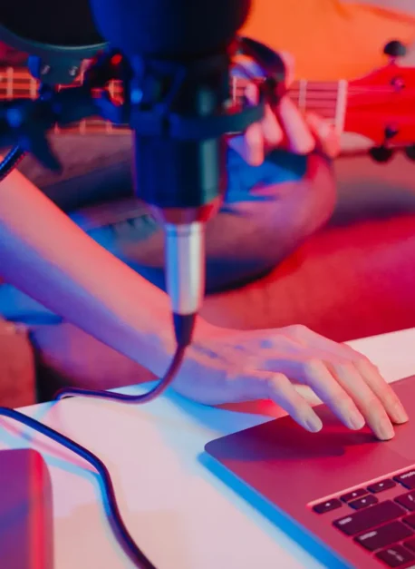 Happy asia girl blogger play guitar and use microphone sing song Happy asia girl blogger play guitar and use microphone sing song record music sound mixer on laptop in modern living room home studio at night. Music content creator, Tutorial, Broadcast concept.